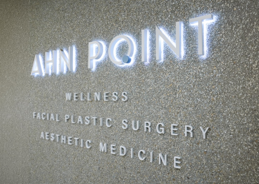 Illuminated Ahn Point sign reading Wellness, Facial Plastic Surgery, Aesthetic Medicine at the Wellesley office