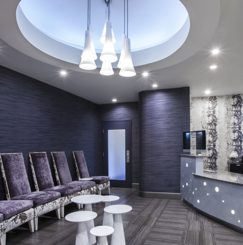 Upholstered waiting-room chairs beside a lit reception counter at the Westborough office